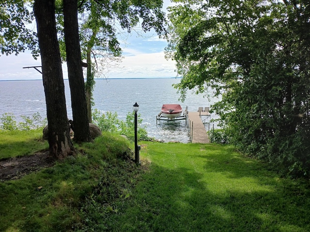 11160 Ottertail Point Dr NW, Cass Lake, MN 56633 - view of green lawn with a water view and a dock