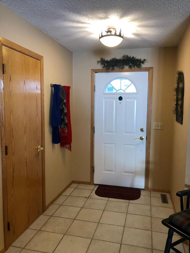 11160 Ottertail Point Dr NW, Cass Lake, MN 56633 - entrance foyer featuring light tile patterned floors and a textured ceiling