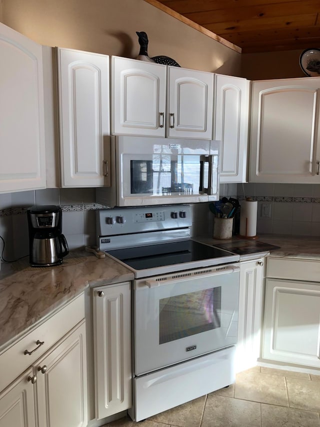 11160 Ottertail Point Dr NW, Cass Lake, MN 56633 - kitchen with white electric range oven, wood ceiling, backsplash, and white cabinets