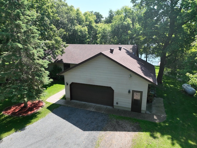 11160 Ottertail Point Dr NW, Cass Lake, MN 56633 - view of home's exterior with a yard, an attached garage, asphalt driveway, and a shingled roof