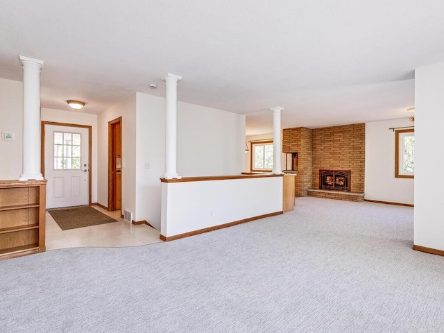 7651 86th St, Bloomington, MN 55438 - unfurnished living room featuring plenty of natural light, a fireplace, and ornate columns