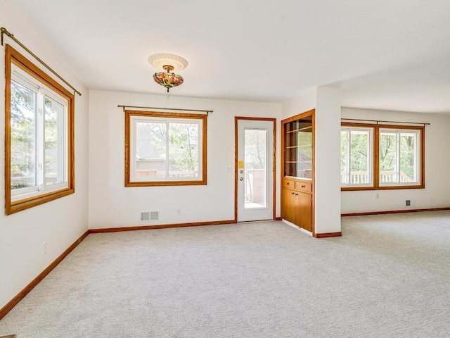 7651 86th St, Bloomington, MN 55438 - spare room featuring light carpet and baseboards