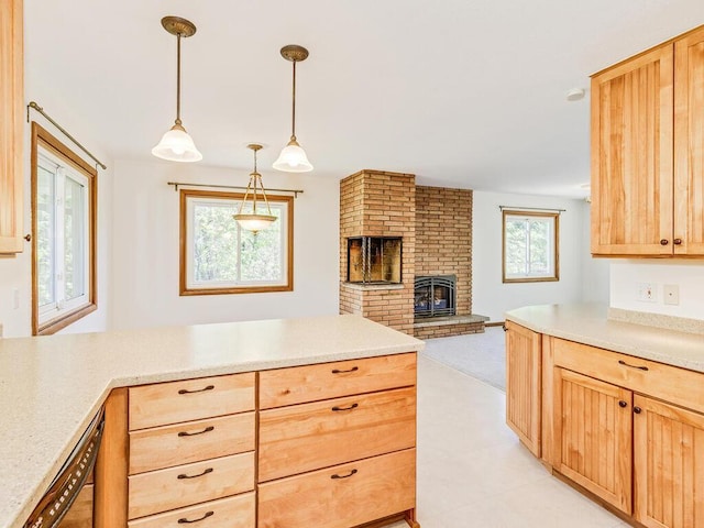 7651 86th St, Bloomington, MN 55438 - kitchen featuring light brown cabinets, light countertops, open floor plan, a brick fireplace, and hanging light fixtures