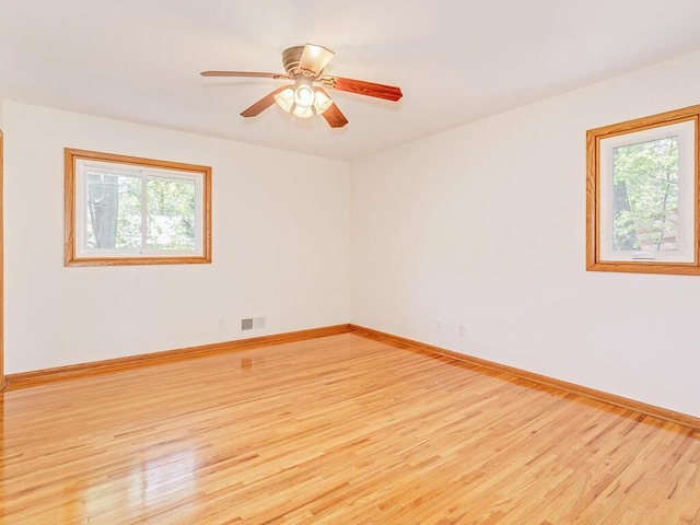 7651 86th St, Bloomington, MN 55438 - empty room featuring healthy amount of natural light, light wood-style flooring, and a ceiling fan