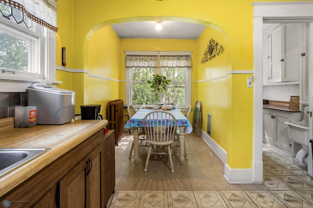 101 3rd Ave SW, Lidgerwood, ND 58053 - dining room with arched walkways and light tile patterned flooring