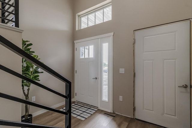 2216 Lake Ave, New Ulm, MN 56073 - entryway featuring wood finished floors, stairs, and a high ceiling