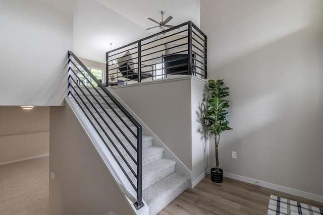2216 Lake Ave, New Ulm, MN 56073 - staircase featuring ceiling fan, a high ceiling, and wood finished floors