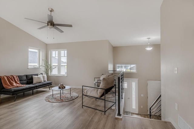 2216 Lake Ave, New Ulm, MN 56073 - living area with wood finished floors, ceiling fan, stairway, and high vaulted ceiling