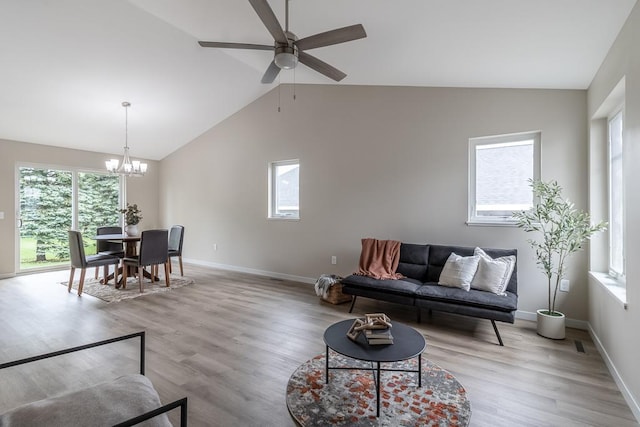 2216 Lake Ave, New Ulm, MN 56073 - living room featuring a chandelier, ceiling fan, plenty of natural light, light wood-type flooring, and high vaulted ceiling
