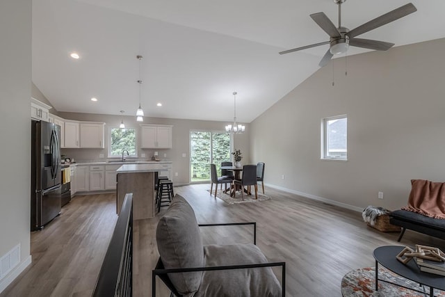 2216 Lake Ave, New Ulm, MN 56073 - living area with a chandelier, high vaulted ceiling, light wood-type flooring, ceiling fan, and recessed lighting