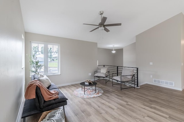 2216 Lake Ave, New Ulm, MN 56073 - living area with a ceiling fan, light wood-style floors, and an upstairs landing