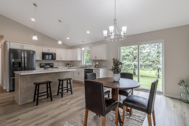 2216 Lake Ave, New Ulm, MN 56073 - dining area with light wood-type flooring, a chandelier, recessed lighting, and high vaulted ceiling