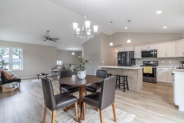 2216 Lake Ave, New Ulm, MN 56073 - dining area with light wood-type flooring, a ceiling fan, high vaulted ceiling, and a chandelier