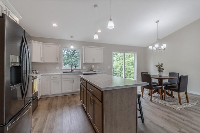 2216 Lake Ave, New Ulm, MN 56073 - kitchen featuring refrigerator with ice dispenser, lofted ceiling, light wood-style flooring, plenty of natural light, and recessed lighting