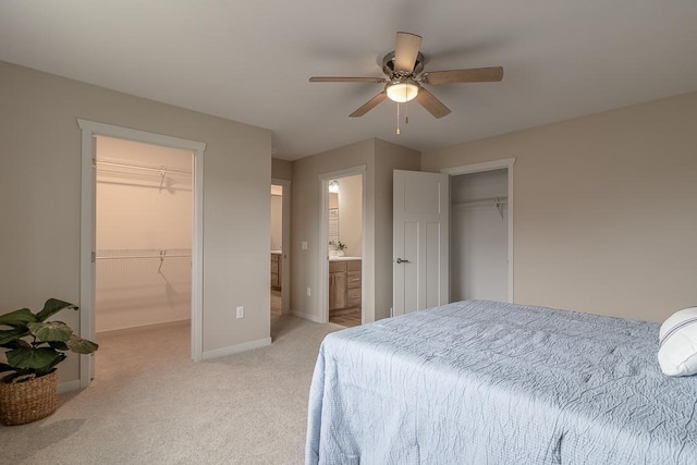 2216 Lake Ave, New Ulm, MN 56073 - bedroom with a walk in closet, light carpet, ensuite bath, and ceiling fan