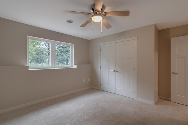 2216 Lake Ave, New Ulm, MN 56073 - unfurnished bedroom with a closet, light colored carpet, and a ceiling fan
