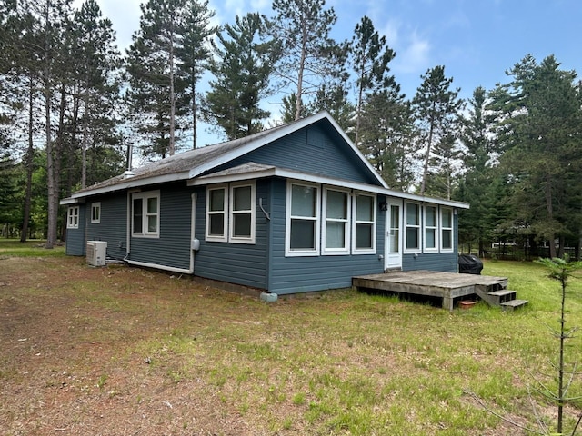 29184 Jana Rd, Scott Twp, WI 54830 - rear view of house featuring a deck, a yard, and view of wooded area
