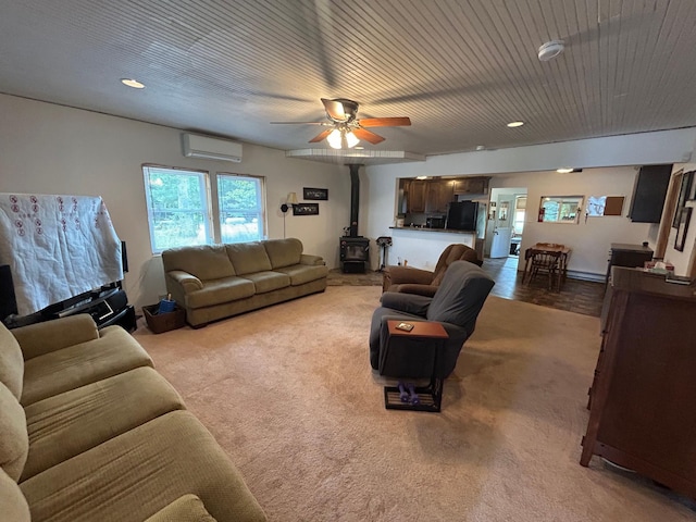 29184 Jana Rd, Scott Twp, WI 54830 - living room with a wood stove, a wall unit AC, ceiling fan, and carpet floors