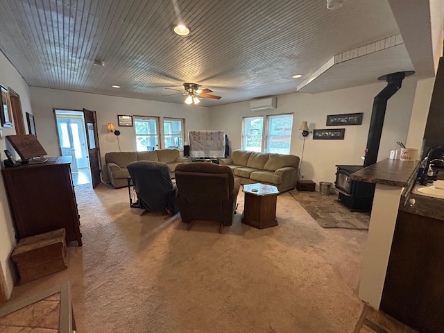 29184 Jana Rd, Scott Twp, WI 54830 - living area featuring a wood stove, a wall mounted air conditioner, light carpet, ceiling fan, and healthy amount of natural light
