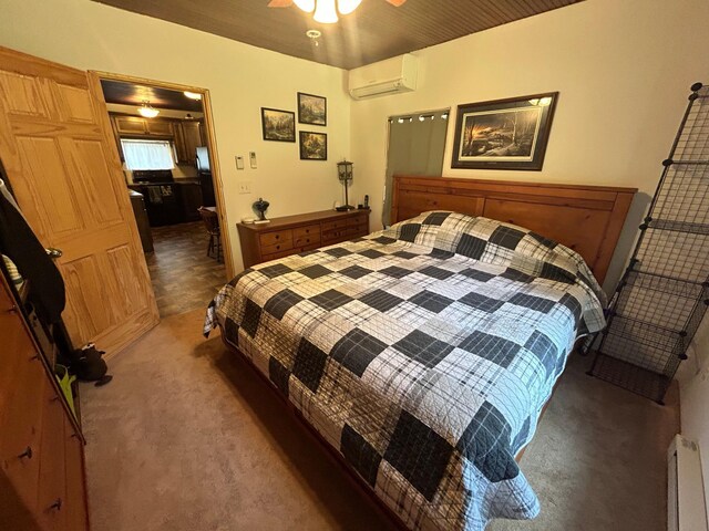 29184 Jana Rd, Scott Twp, WI 54830 - carpeted bedroom with a wall mounted AC, baseboard heating, and a ceiling fan