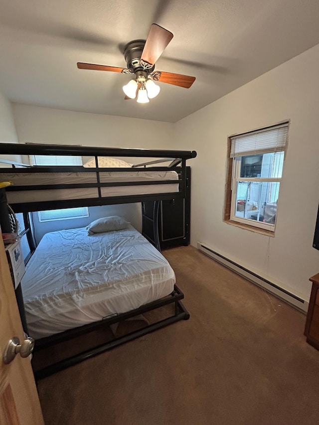29184 Jana Rd, Scott Twp, WI 54830 - carpeted bedroom featuring a baseboard heating unit and a ceiling fan