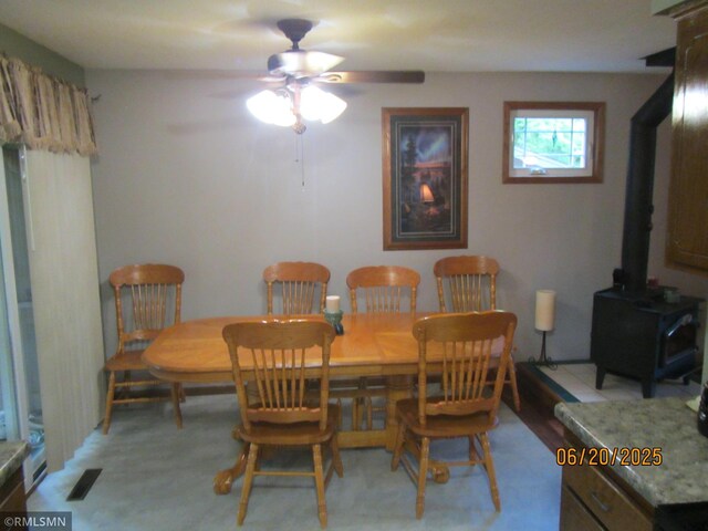 10445 215th Street Ct N, Scandia, MN 55073 - dining area with a ceiling fan and a wood stove