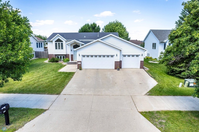 152 17th Ave W, West Fargo, ND 58078 - view of front facade featuring brick siding, a front lawn, concrete driveway, and a garage