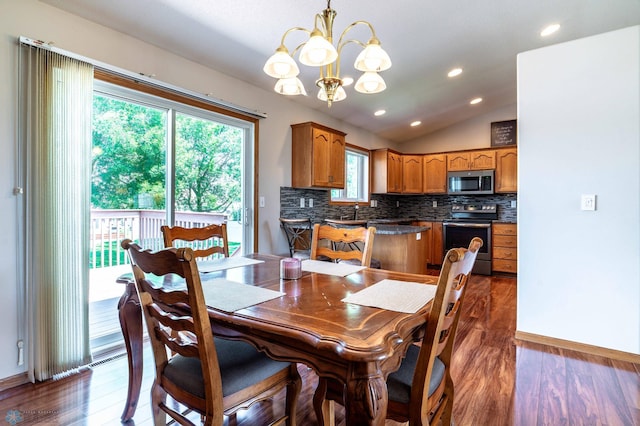 152 17th Ave W, West Fargo, ND 58078 - dining space featuring healthy amount of natural light, a chandelier, lofted ceiling, wood finished floors, and recessed lighting