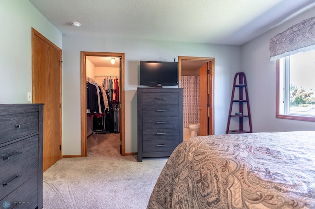 152 17th Ave W, West Fargo, ND 58078 - bedroom featuring a spacious closet, light colored carpet, a closet, and connected bathroom