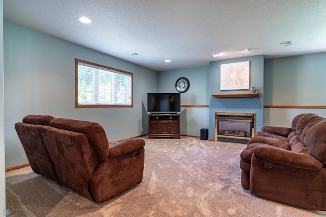 152 17th Ave W, West Fargo, ND 58078 - carpeted living area with a glass covered fireplace, recessed lighting, and a textured ceiling