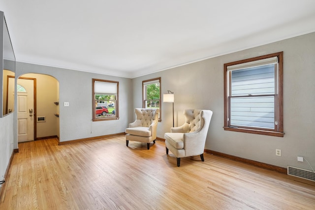 1215 Palace Ave, Saint Paul, MN 55105 - living area featuring ornamental molding, arched walkways, and light wood-style flooring