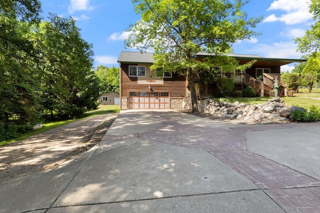 3170 Stark Rd, Fish Lake Twp, MN 55032 - view of front of home featuring stairway, stone siding, a garage, driveway, and a porch