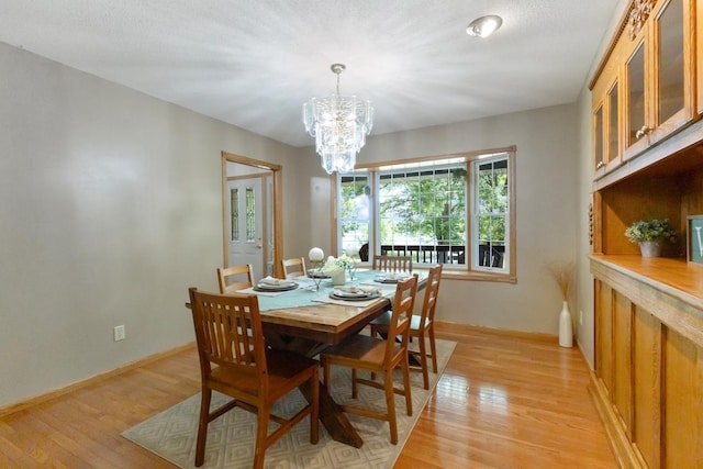 3170 Stark Rd, Fish Lake Twp, MN 55032 - dining room featuring a chandelier and light wood-style floors