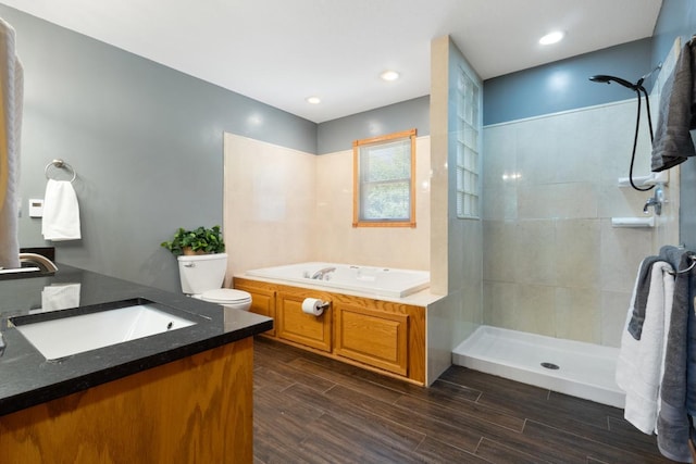 3170 Stark Rd, Fish Lake Twp, MN 55032 - bathroom featuring a garden tub, tiled shower, vanity, and wood finished floors