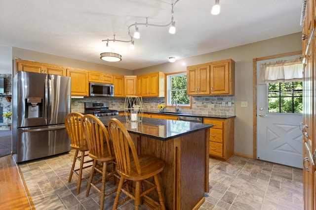 3170 Stark Rd, Fish Lake Twp, MN 55032 - kitchen with stainless steel appliances, tasteful backsplash, a center island, and a breakfast bar