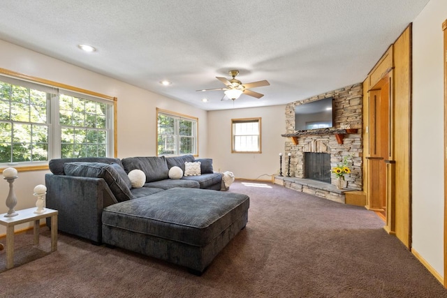 3170 Stark Rd, Fish Lake Twp, MN 55032 - living area featuring carpet flooring, a ceiling fan, a stone fireplace, a textured ceiling, and recessed lighting