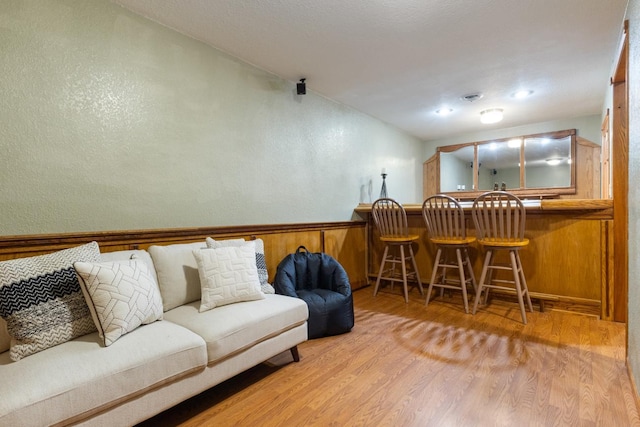 3170 Stark Rd, Fish Lake Twp, MN 55032 - living area featuring a dry bar, wood finished floors, and a wainscoted wall