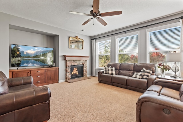 9871 7th St N, Lake Elmo, MN 55042 - living room featuring carpet, a ceiling fan, a stone fireplace, and a textured ceiling