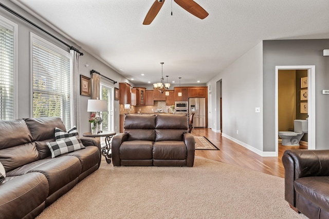 9871 7th St N, Lake Elmo, MN 55042 - living room featuring light carpet, a chandelier, ceiling fan, recessed lighting, and a textured ceiling