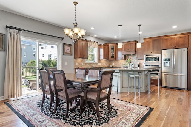 9871 7th St N, Lake Elmo, MN 55042 - dining room with light wood-style flooring, a chandelier, and recessed lighting