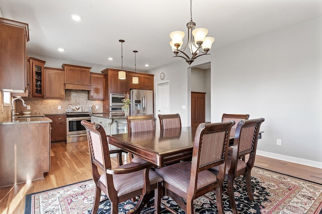 9871 7th St N, Lake Elmo, MN 55042 - dining space featuring a chandelier, recessed lighting, and light wood-type flooring