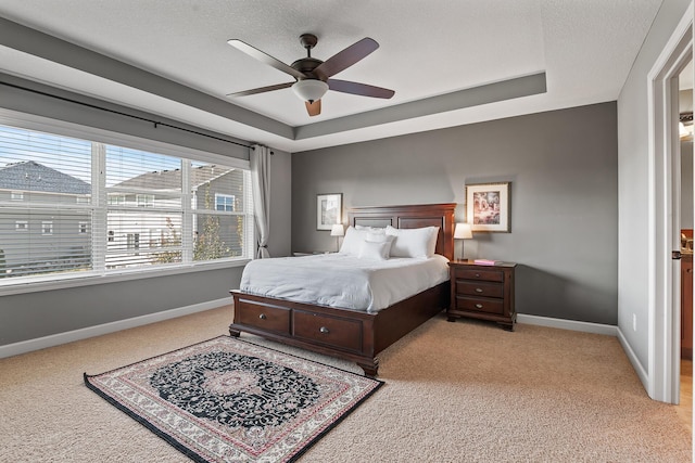 9871 7th St N, Lake Elmo, MN 55042 - bedroom with light colored carpet, a raised ceiling, and ceiling fan