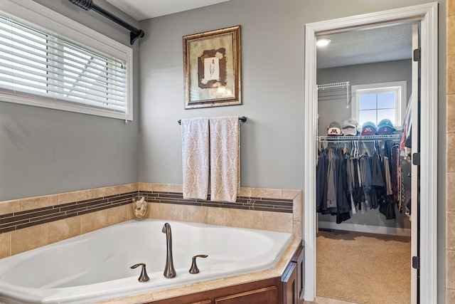 9871 7th St N, Lake Elmo, MN 55042 - full bath featuring a bath and a walk in closet