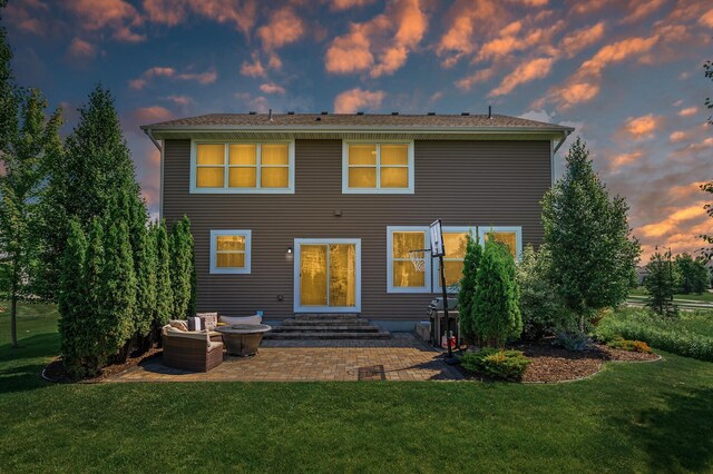 9871 7th St N, Lake Elmo, MN 55042 - back of house at dusk with a patio area, a lawn, and entry steps