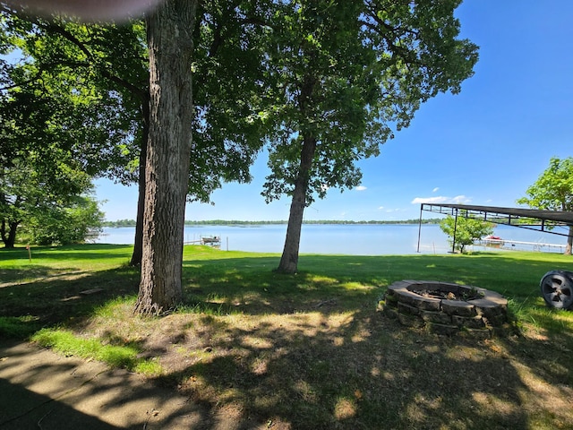 43585 Hidden Trl, Ottertail, MN 56571 - view of green lawn featuring a fire pit and a water view