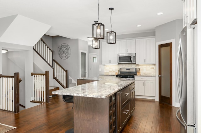 677 Sandstone Cir, Orono, MN 55356 - kitchen featuring stainless steel appliances, decorative backsplash, dark wood-type flooring, white cabinets, and recessed lighting