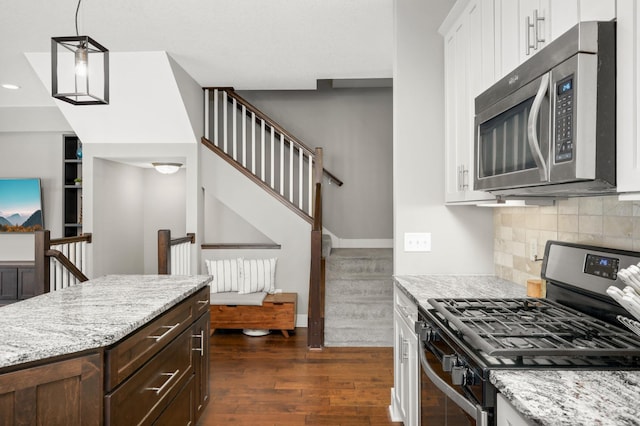 677 Sandstone Cir, Orono, MN 55356 - kitchen featuring appliances with stainless steel finishes, dark wood-style flooring, white cabinetry, dark brown cabinets, and light stone countertops