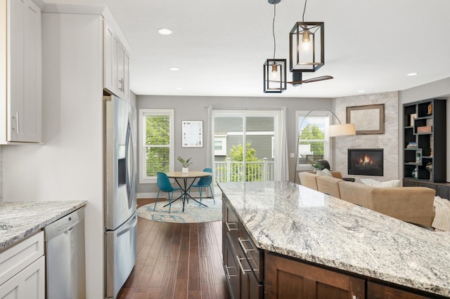 677 Sandstone Cir, Orono, MN 55356 - kitchen with stainless steel appliances, dark wood-type flooring, a high end fireplace, white cabinetry, and recessed lighting