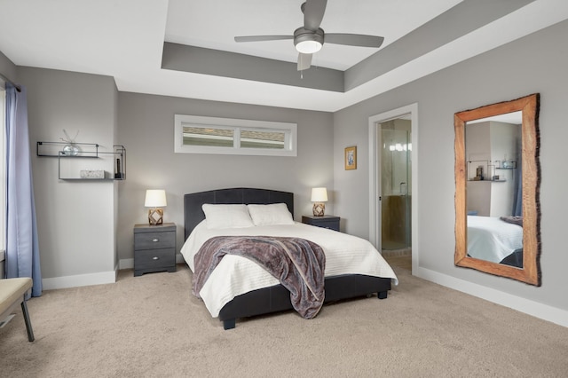 677 Sandstone Cir, Orono, MN 55356 - carpeted bedroom featuring connected bathroom, a ceiling fan, and a tray ceiling