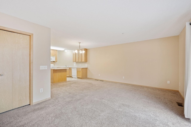 17641 69th Pl N, Maple Grove, MN 55311 - unfurnished living room with light carpet and a chandelier